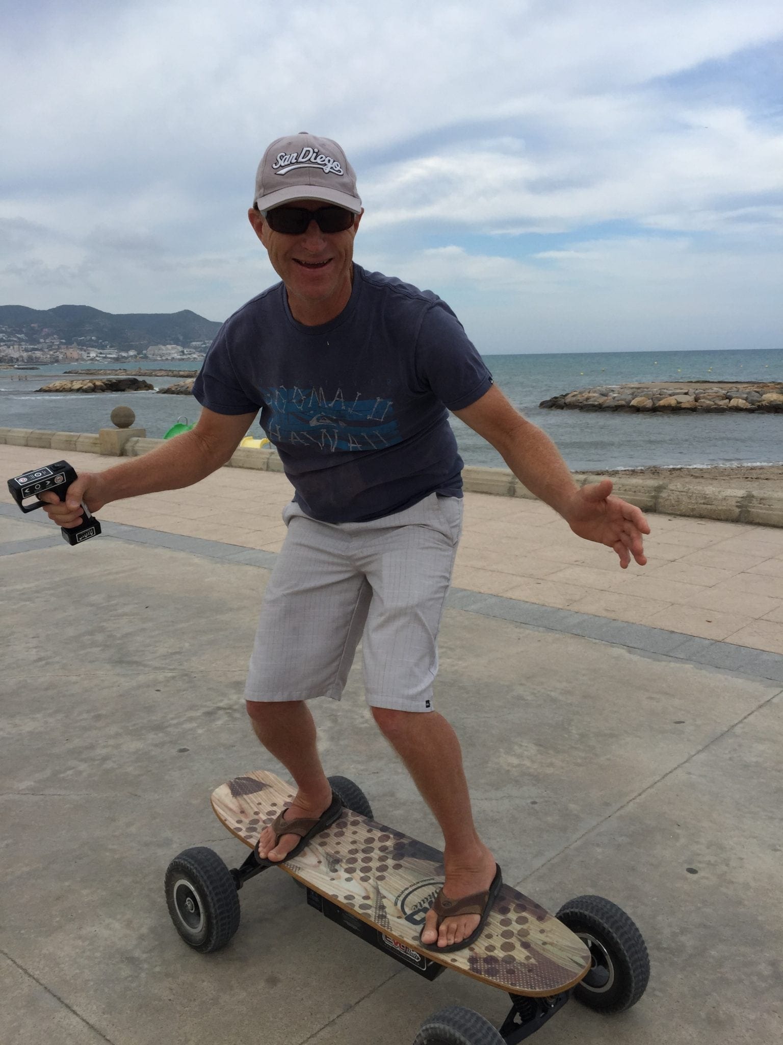 Jim chose an electric skateboard. The power comes from a lithium battery. He is holding the variable speed controller for in his hand. 