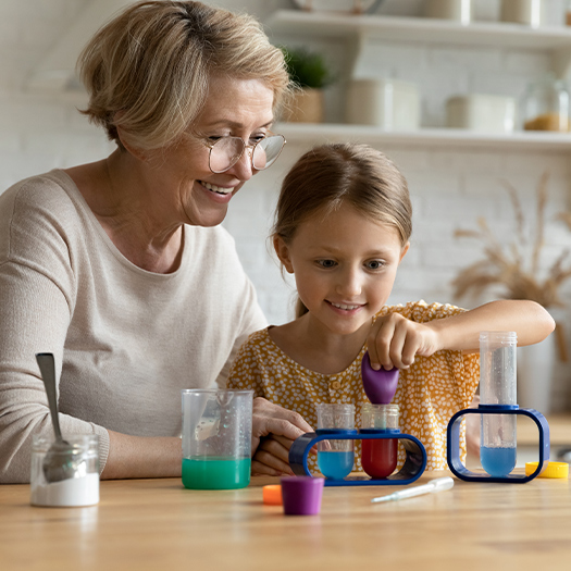 a grandmother and granddaughter doing a science experiment together