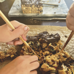 Edible Fossil Dig - Two Children Digging Through Cookie to Find Fossils (Candy)