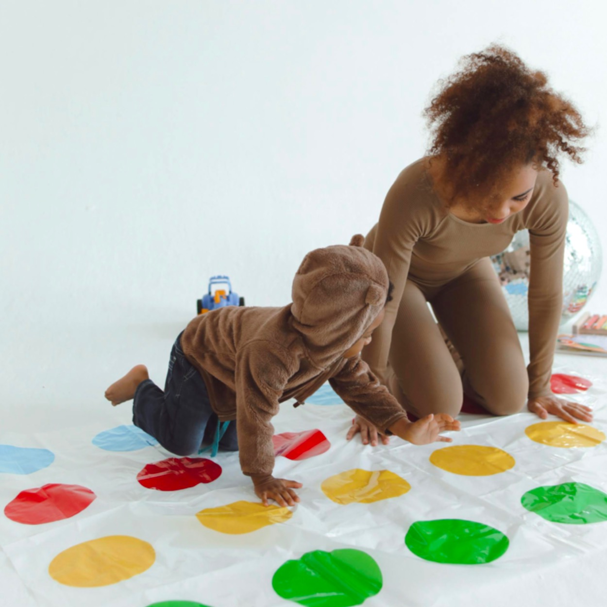 Games Based Learning - Woman and Child Playing Twister Game