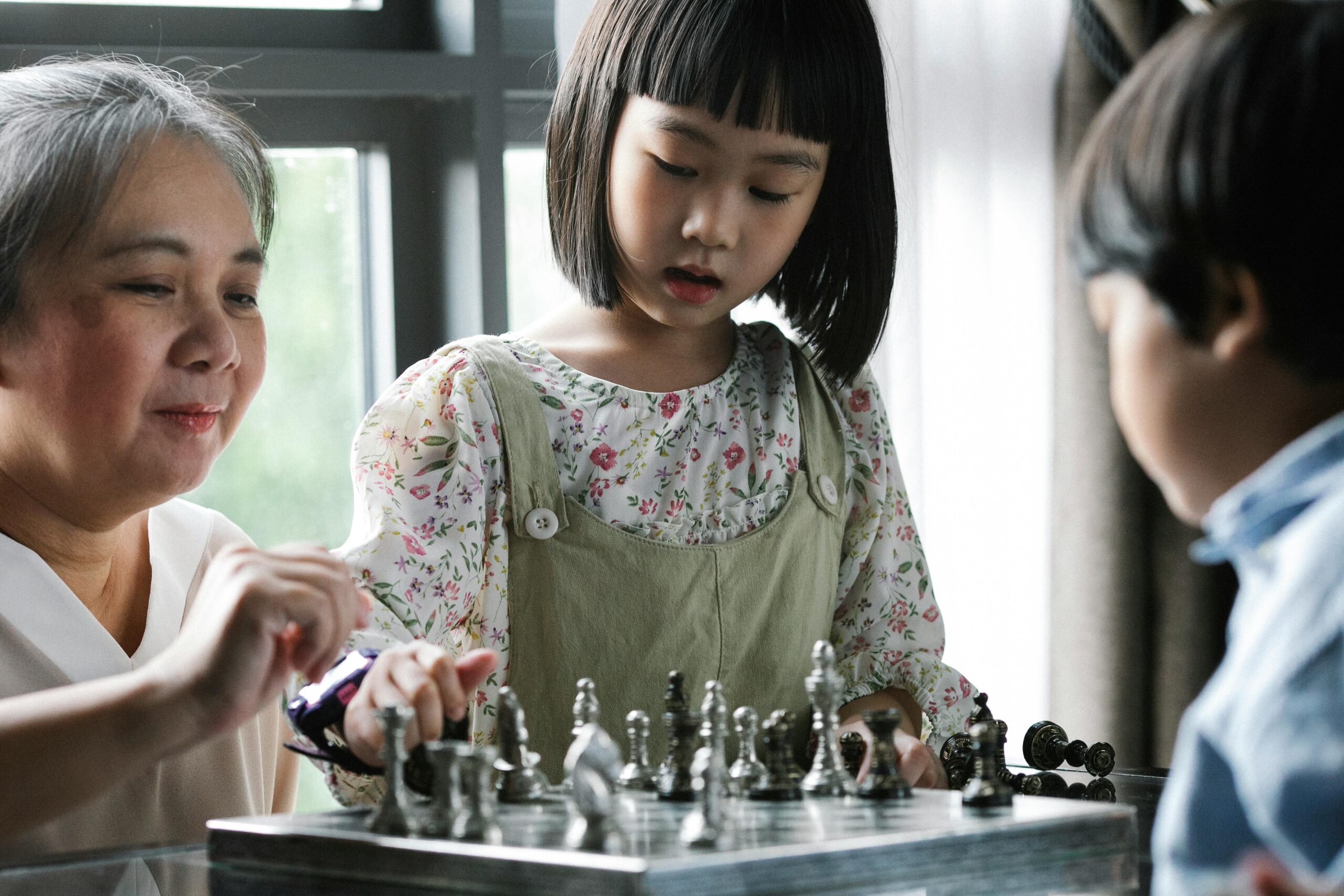 Games Based Learning; Family Playing a Game of Chess