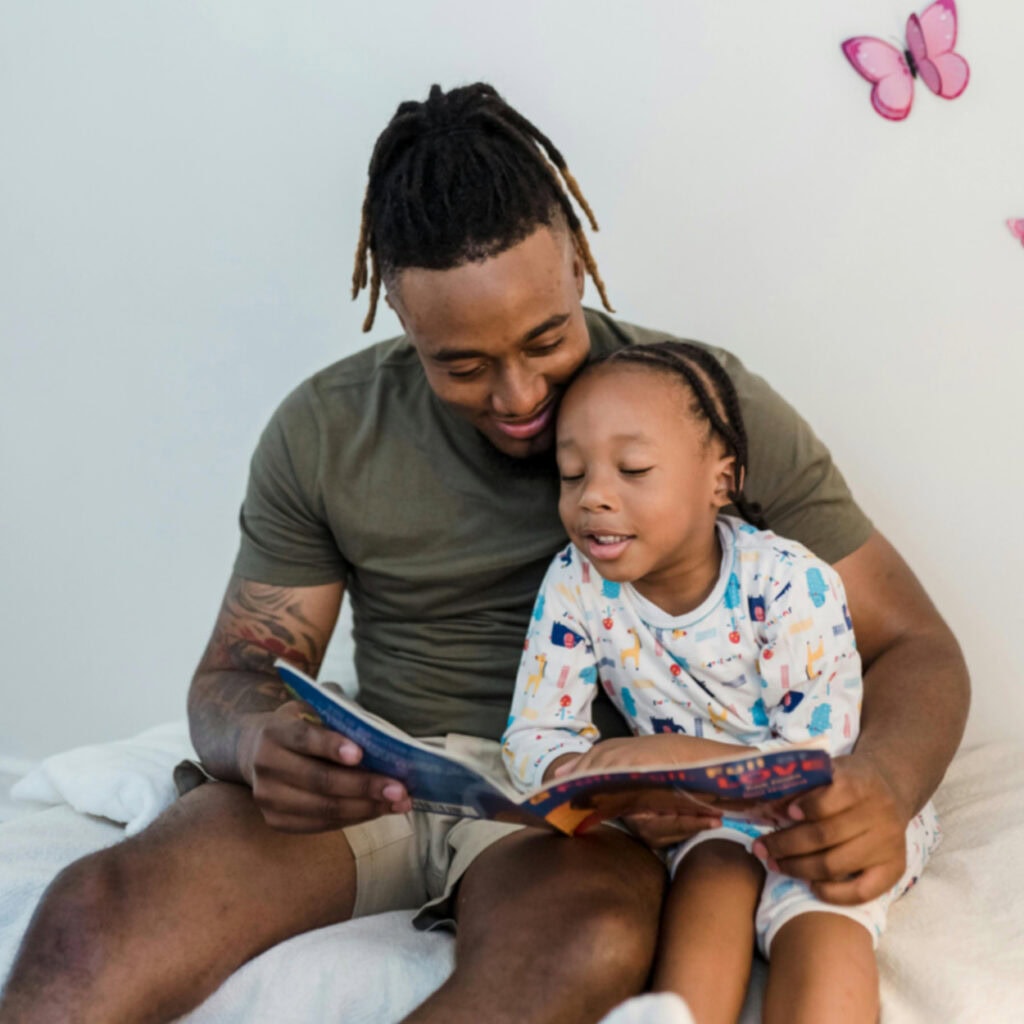 How to Host a Virtual Book Club Reading for book club - Man And Child Sit Together Reading a Book