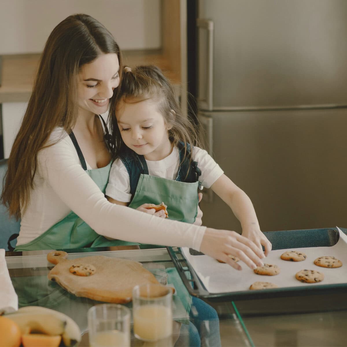 Homeschool Science Activity: Chocolate Chip Cookie Chemistry Homeschool Science Activity: Chocolate Chip Cookie Lab - Woman and Child Placing Cookies on Baking Sheet