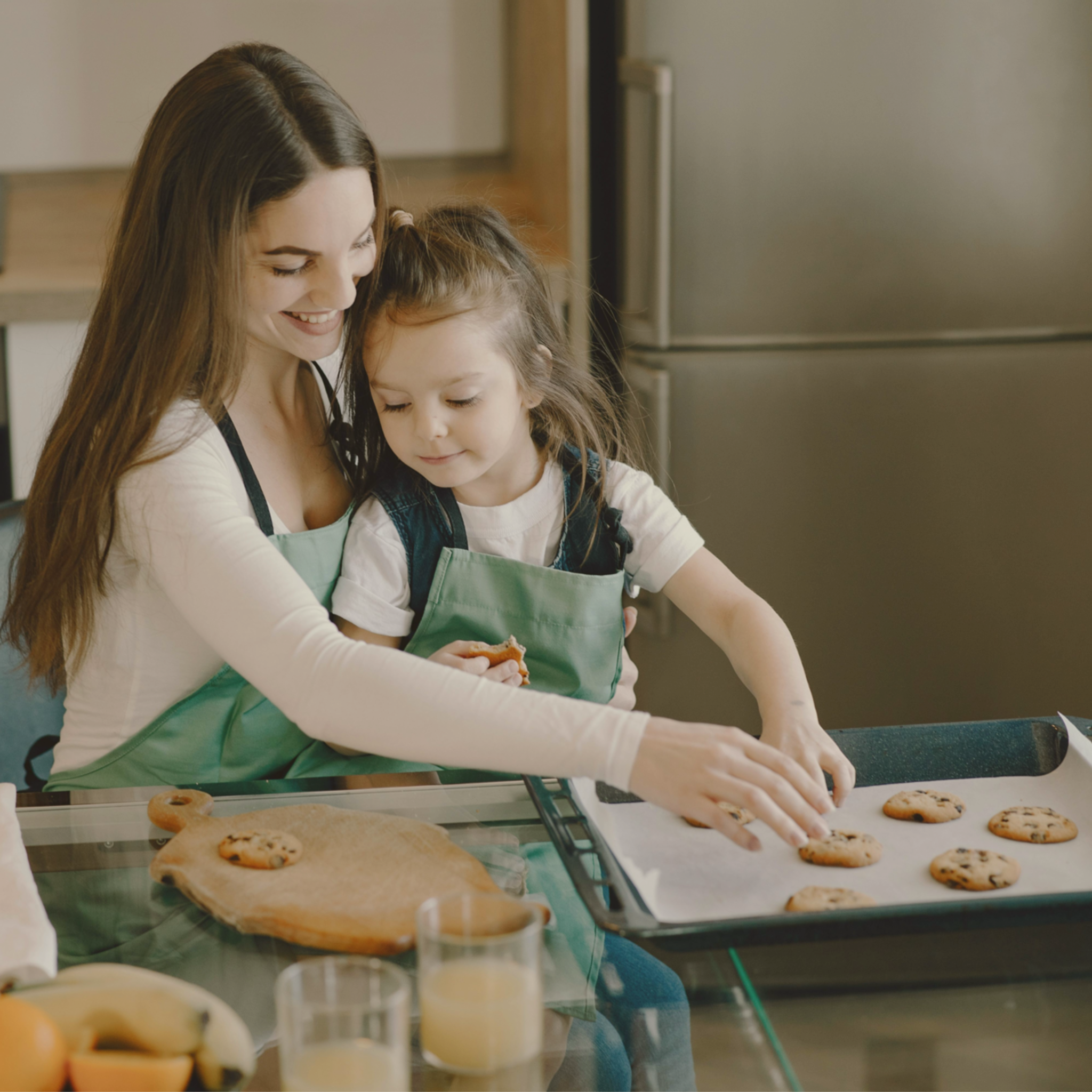 Homeschool Science Activity: Chocolate Chip Cookie Lab - Woman and Child Placing Cookies on Baking Sheet