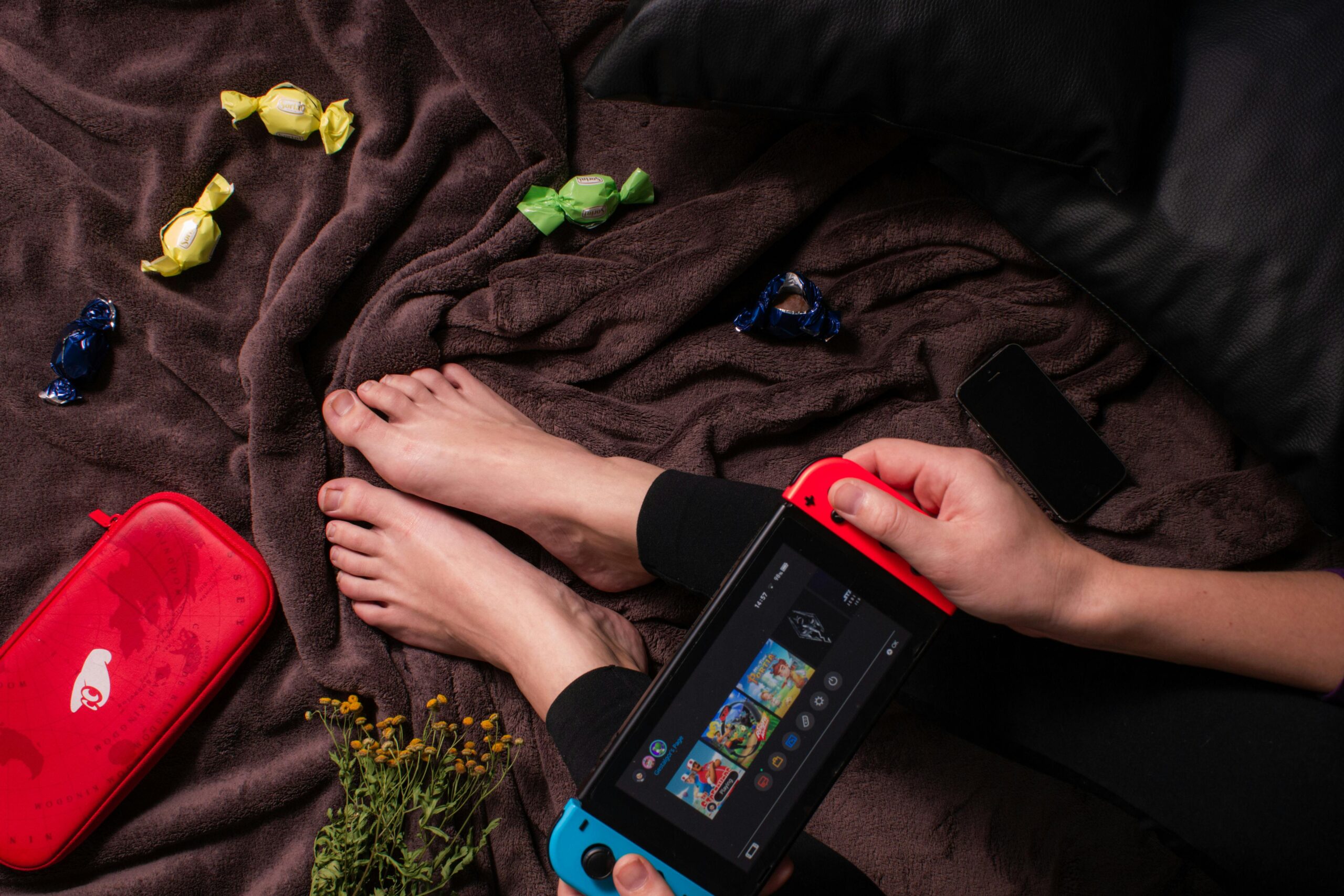 Game Based Learning: Person holds Nintendo Switch While Sitting