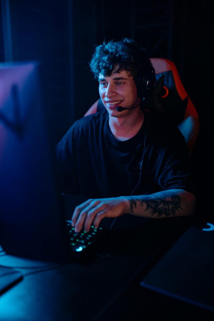 A man in a black shirt playing video games on a computer