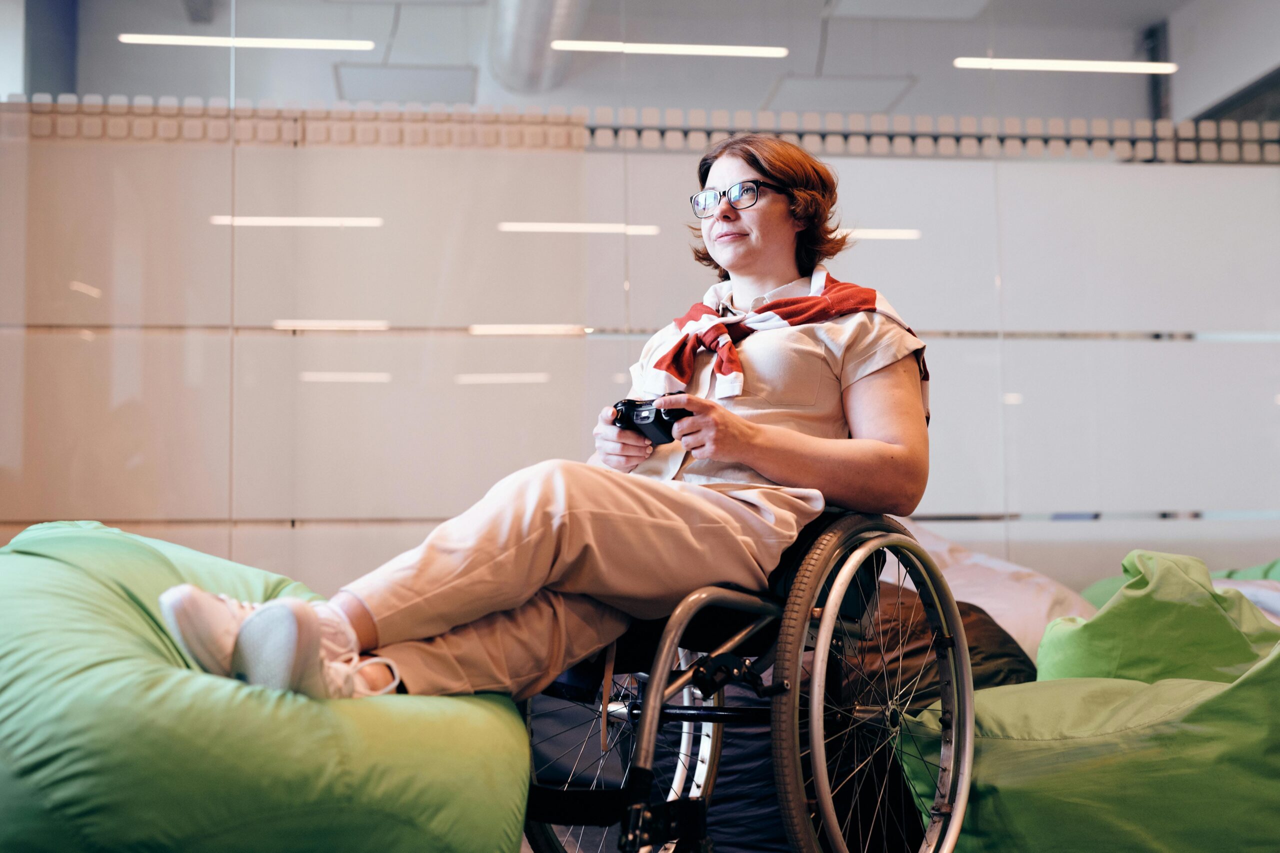 Woman sitting in wheelchair holding video game controller