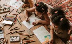 Homeschool Strewing: Children at a table with a lot of art supplies. Each child is working on their own project.