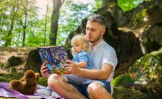 Diverse Books for Children: LGBTQ+ Booklist - Man and Child Sitting in the Forest Reading a Book.